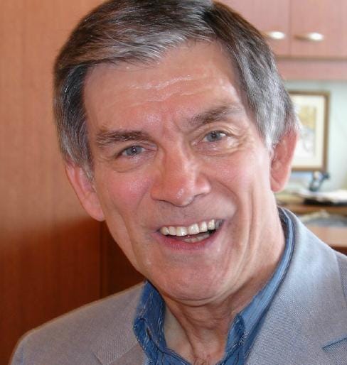 Portait color photo of Jim Hasse, a white middle-aged man without glasses and with a full head of black hair. 