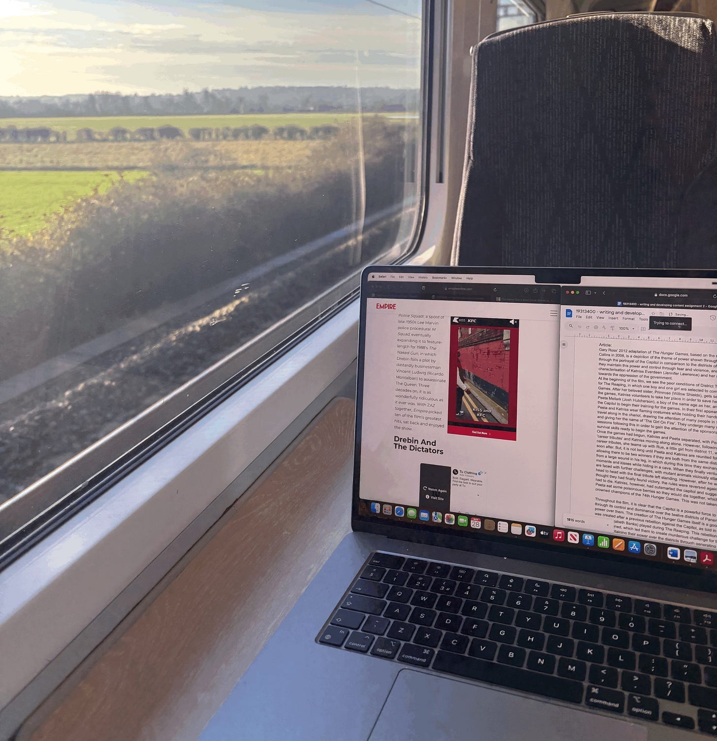 a laptop with school work documents on it next to a window on a train a laptop with school work documents on it next to a window on a train