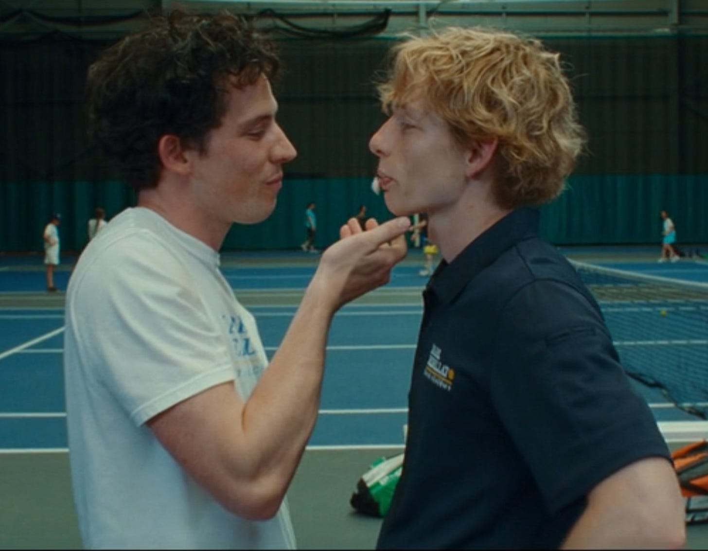 Still from Challengers where Art spits gum into Patrick's hand