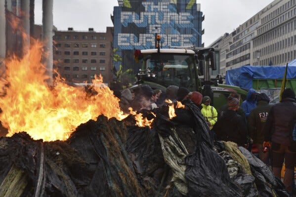 Protesting farmers spray Brussels police with liquid manure near EU's base  in a new display of power | AP News