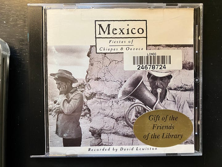 Four photos of a compact disc music player and three Spanish music compact discs (CDs)