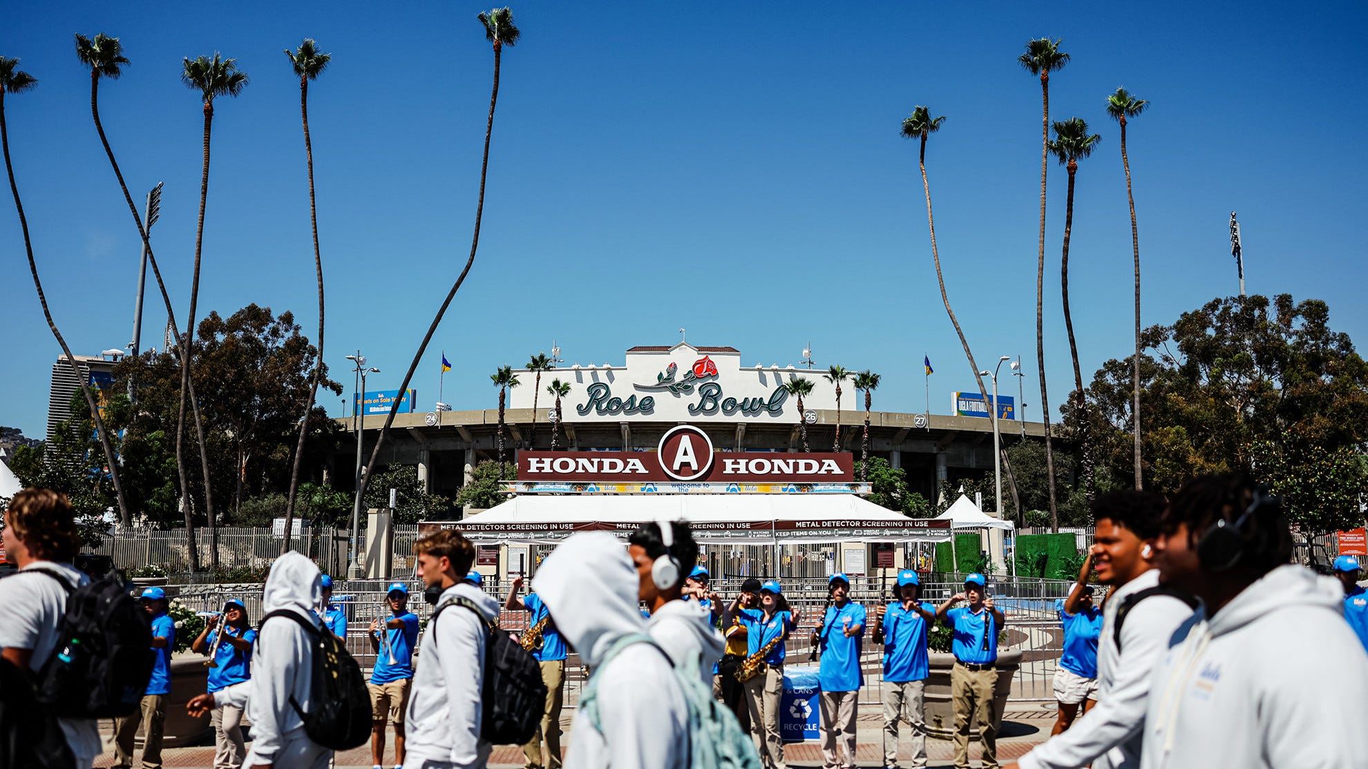 UCLA Football Student-Athletes walk by the Rose Bowl façade during Bruin Walk UCLA Football Student-Athletes walk by the Rose Bowl façade during Bruin Walk