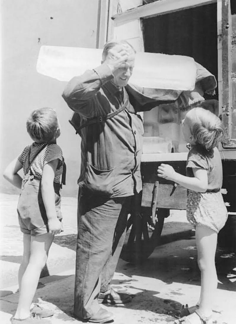 old black and white photo c.1958 of a man pulling a block of ice from his delivery truck as 2 kids look up at him. 1956 summer in the city old black and white photo c.1958 of a man pulling a block of ice from his delivery truck as 2 kids look up at him. 1956 summer in the city
