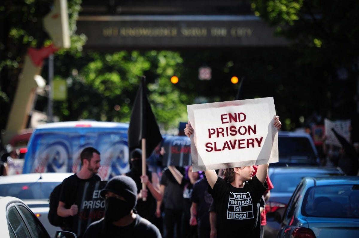 Protesters marched through the streets of Portland, Ore., on September 9, 2016, during a nationwide day of action against prison slavery on the 45th anniversary of the Attica Uprising, which saw the death of twenty-nine prisoners and ten hostages after inmates rioted for better conditions. (Photo by Alex Milan Tracy) *** Please Use Credit from Credit Field ***