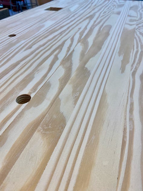 Various images of the workbench showing a crack in the top, gaps in the top being filled, and a plane stop sitting on the top.