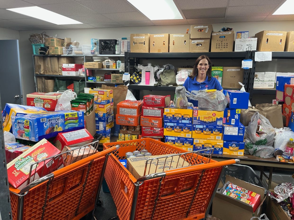 Groceries are piled high as the food pantry organizes their shelves after a food bank delivery.