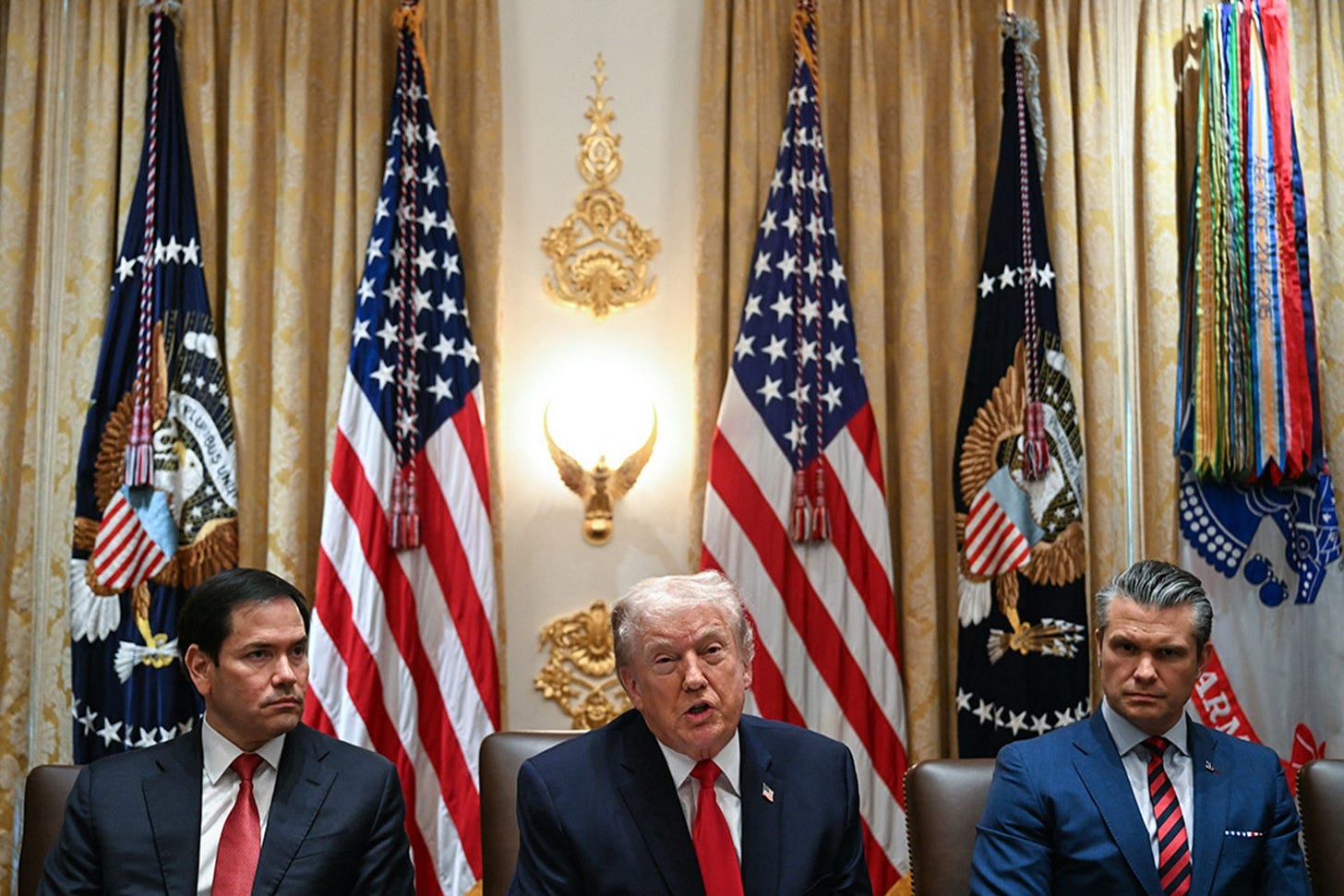 US President Donald Trump speaks alongside Secretary of State Marco Rubio (L) and Defense Secretary Pete Hegseth (R) during a cabinet meeting in the Cabinet Room of the White House in Washington, DC, on January 29, 2026.