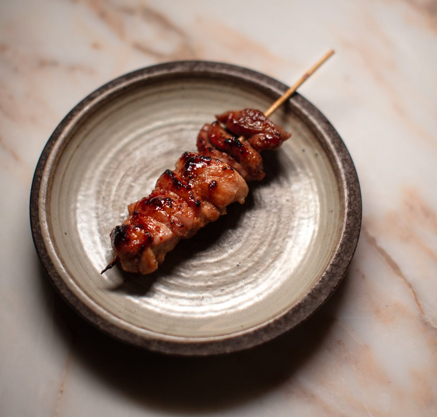 Grilled meat skewer on a plate. Grilled meat skewer on a plate.