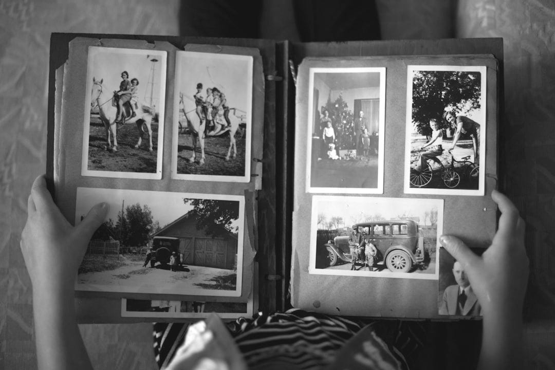 person opening photo album displaying grayscale photos person opening photo album displaying grayscale photos
