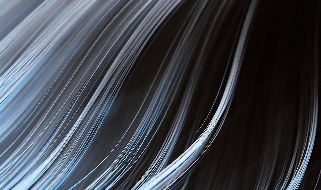 a black and blue background with white streaks