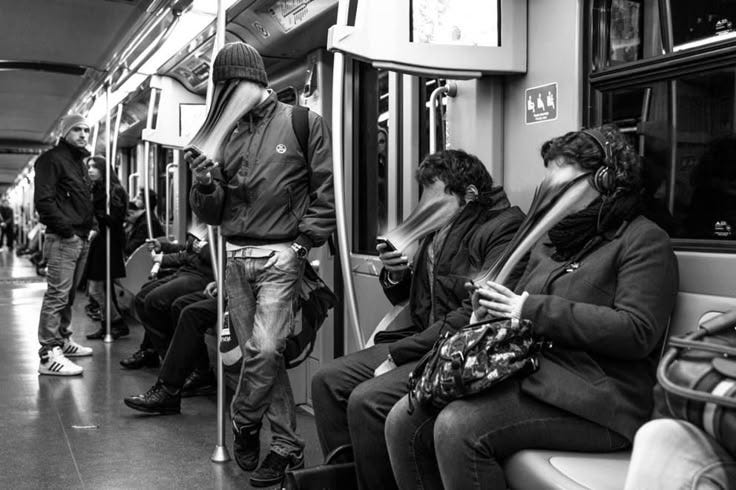 This may contain: people are sitting on the subway looking at their phones This may contain: people are sitting on the subway looking at their phones