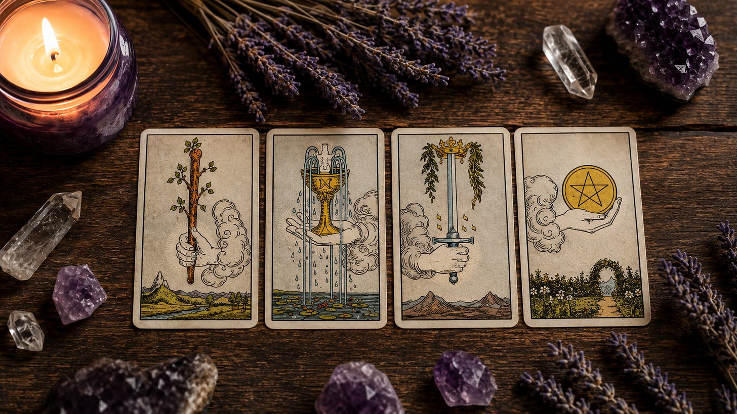 The four Aces of the tarot, Wands, Cups, Swords and Pentacles, laid side by side on dark wood between dried lavender and quartz.