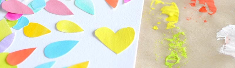Colourful painted paper shapes on a white background featuring a yellow heart in the centre.