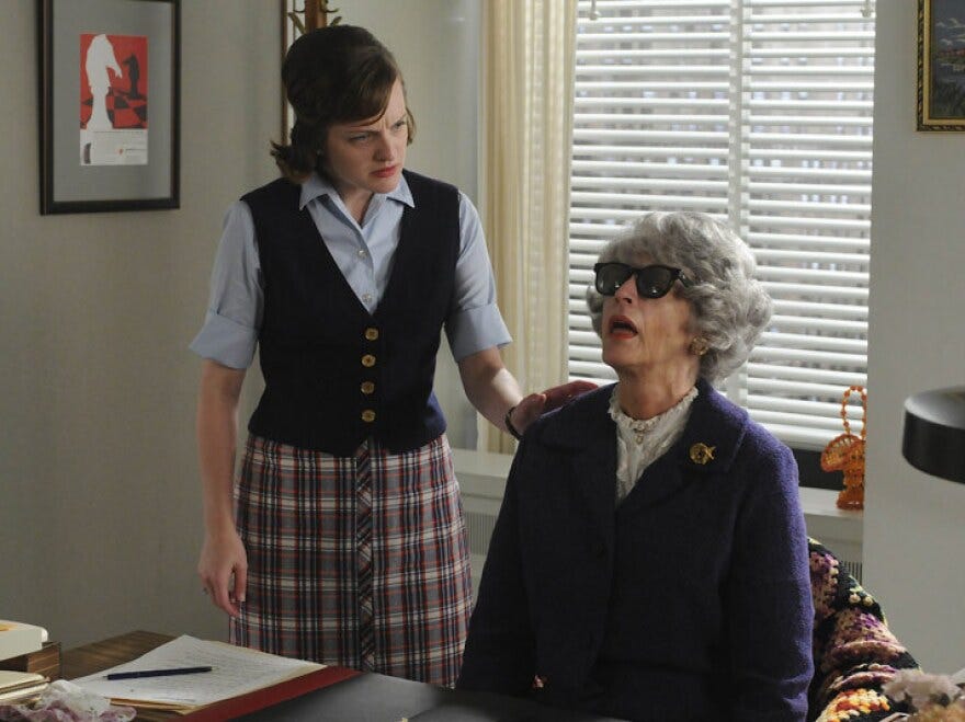 <em>Mad Men</em> leading lady Peggy Olson (Elisabeth Moss, left), discovers the expired Miss Blankenship (Randee Heller).