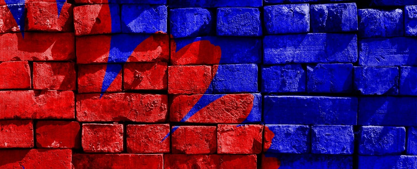 An image of bricks, stacked a little haphazardly. Some have been painted blue.