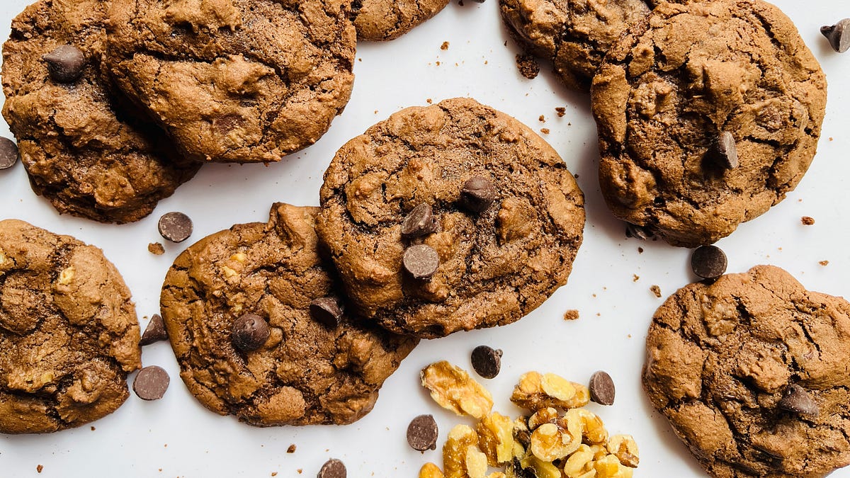 Chocolate chip cookies on a marble cutting board.