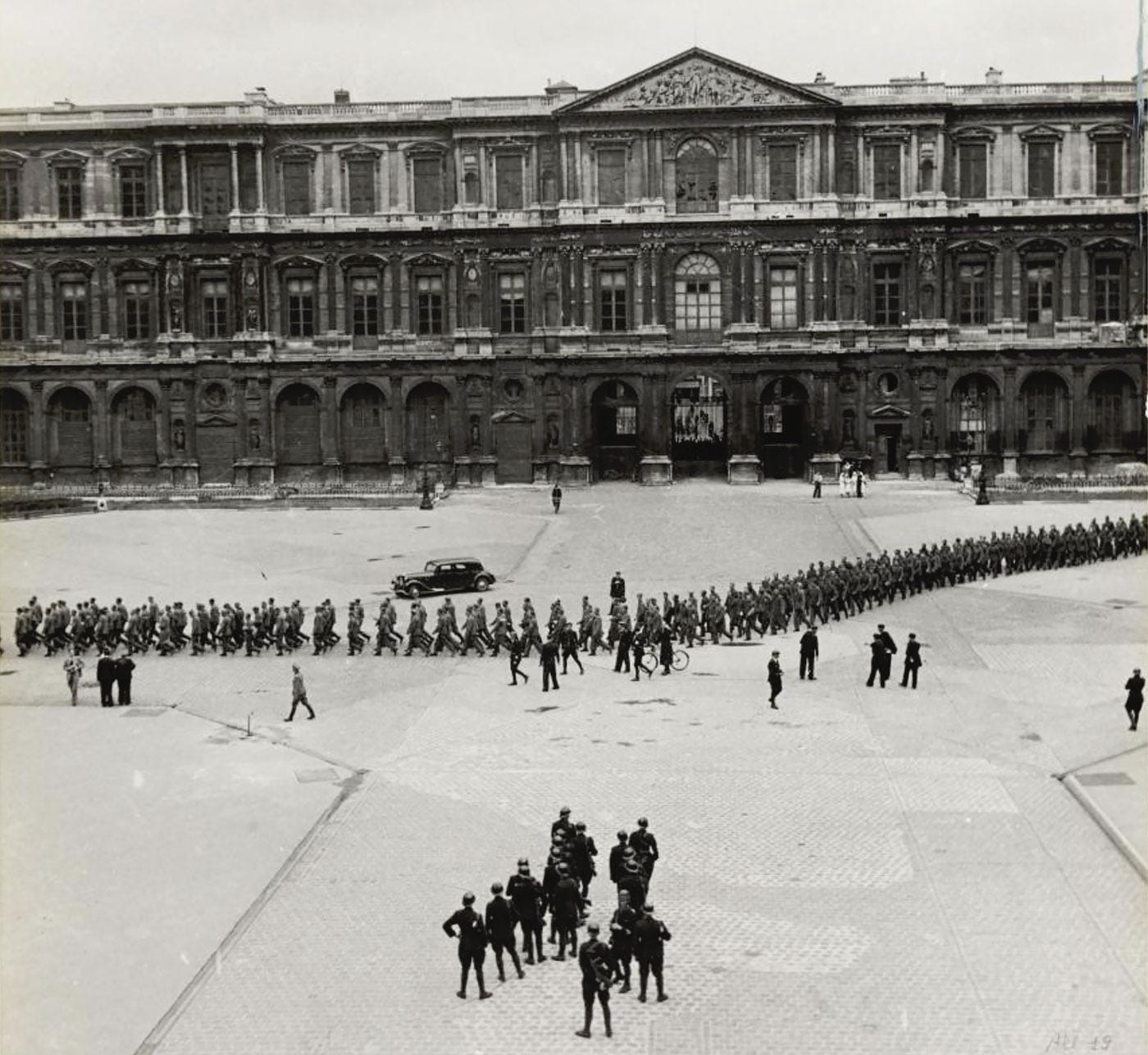 Louvre courtyard during the Liberation of Paris, used as an open-air prison for Nazis.
