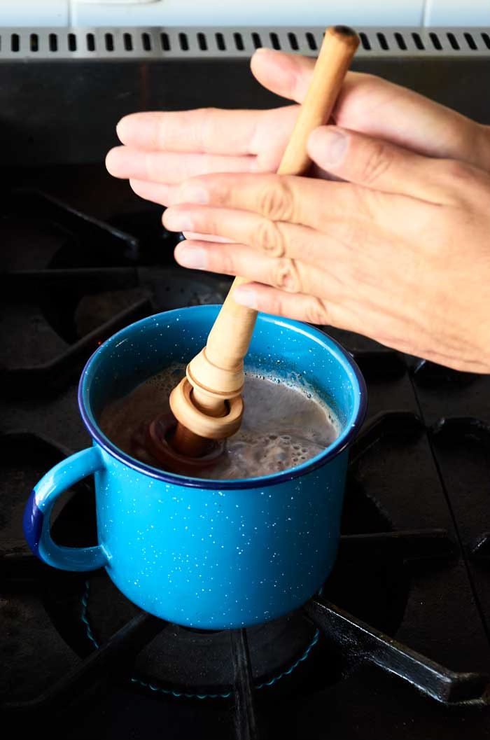 Using a Mexican "molinillo" to froth hot chocolate