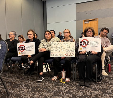 various photographs of the town hall, many people photographed holding signs that read concerns about the dilapidated building in question.