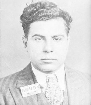 A person in a suit with a number tag

Description automatically generated