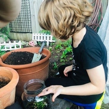 A person watering plants in a potDescription automatically generated with low confidence