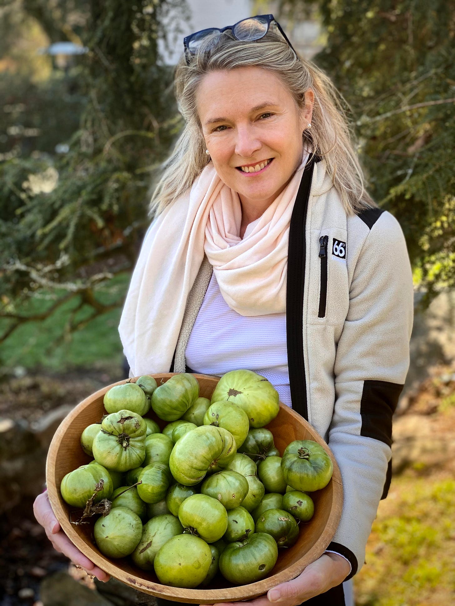 Lauren Driscoll, Founder and CEO of NourishedRX hold a bowl of green tomatoes