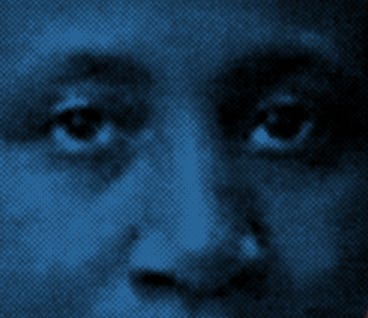 A close up of Mary A.'s face where her eyes and nose are visible. The image is dark blue and black