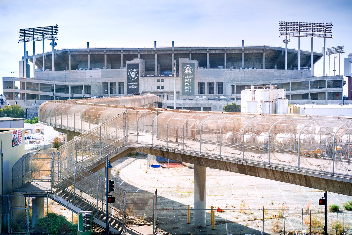 Pedestrian bridge connecting the BART transit stop and the Oakland Coliseum Complex. (Image source: Adobe Stock / Oakland Report)