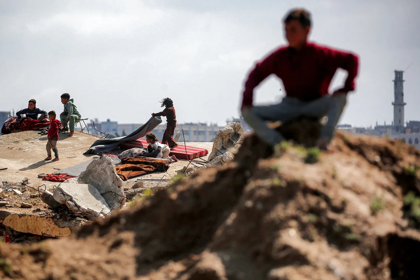Lebanese children sit on rubble
