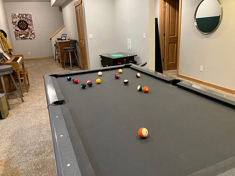 Ping pong, pool, Pac-Man, TV entertainment center, and dart board