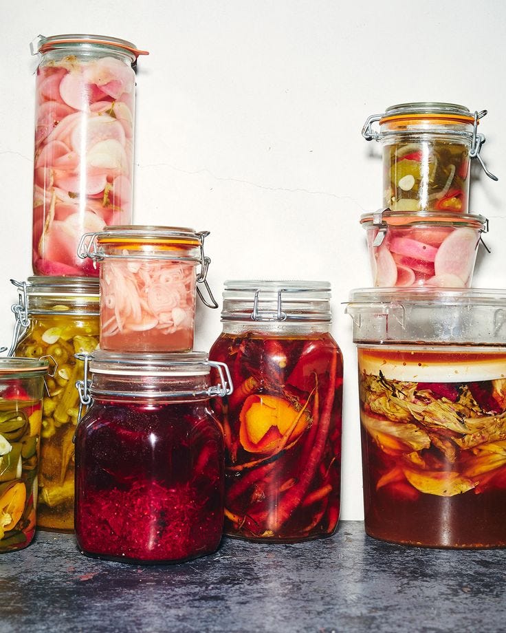 This may contain: several jars filled with different types of food