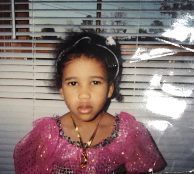 Five year old Kiana in a ballerina costume staring at the camera with disgust