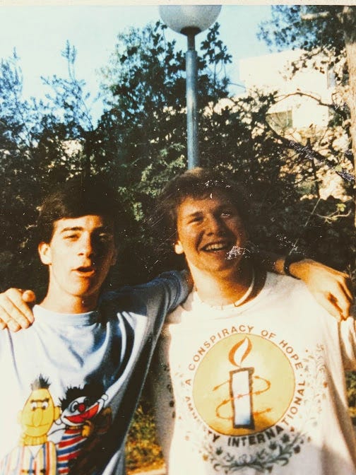 A couple of men posing for a picture

Description automatically generated