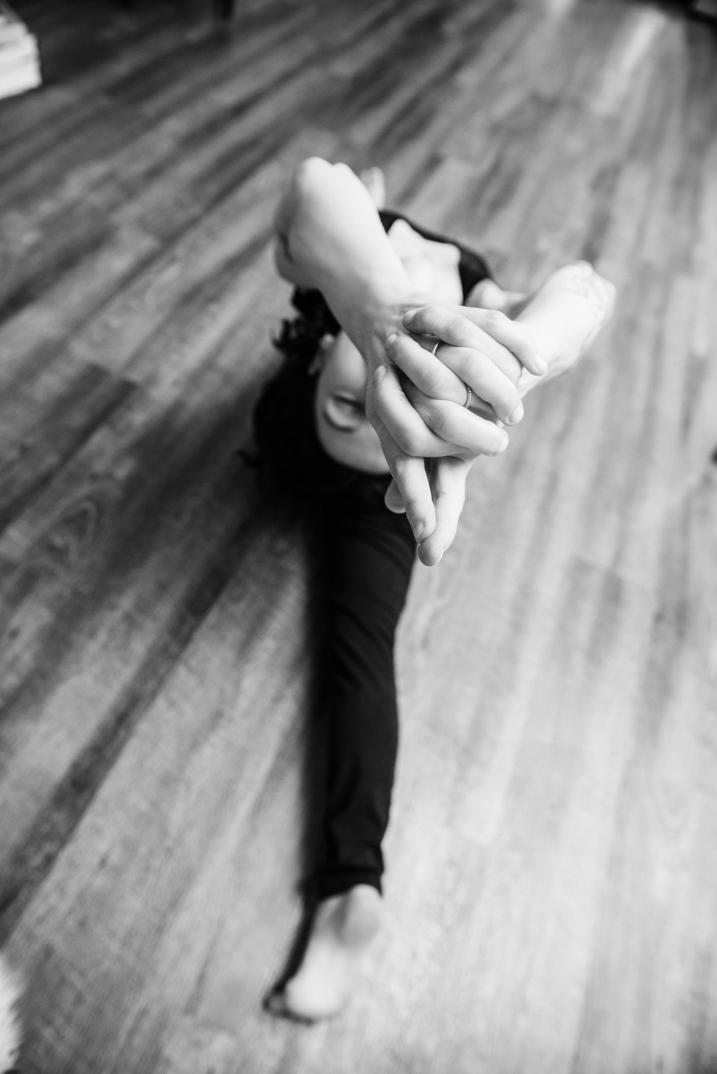 Author doing a backbend while in a split and looking blissful