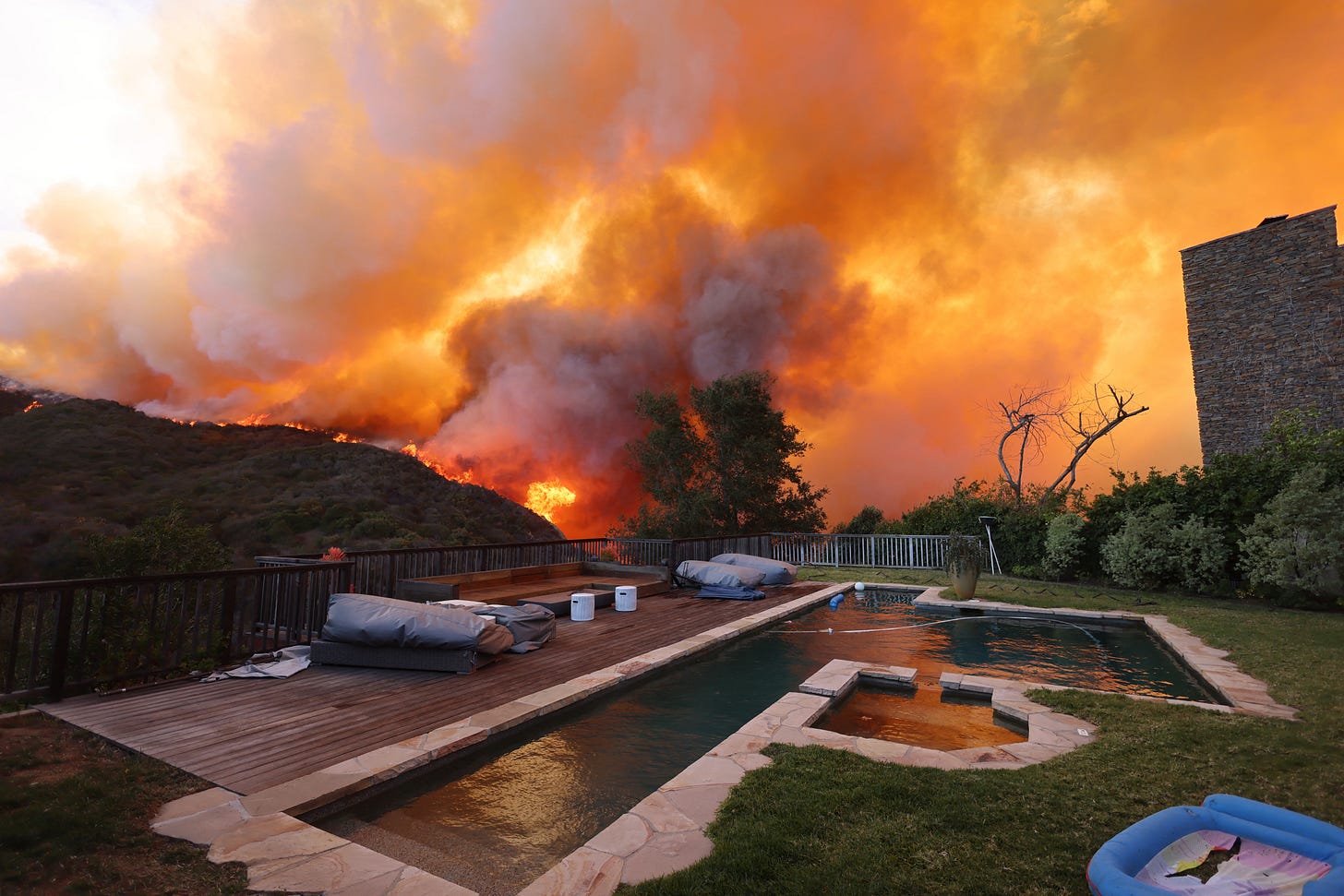 wildfire in california with a swimming pool in foreground and smoke in background wildfire in california with a swimming pool in foreground and smoke in background