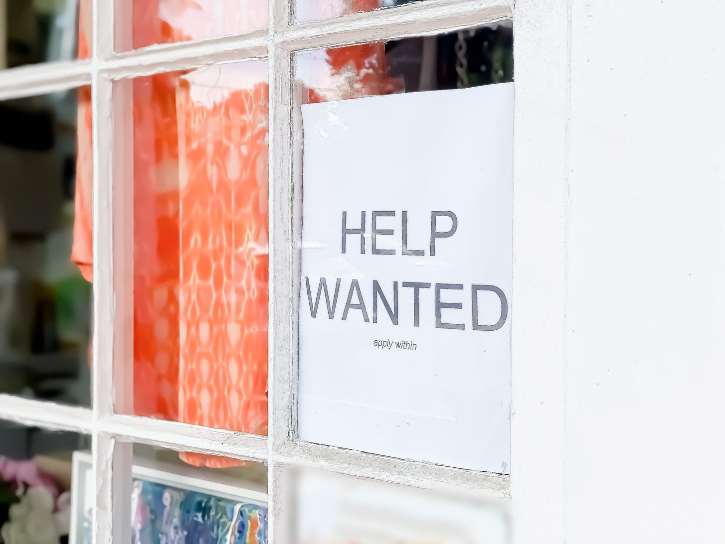 Help Wanted sign in store window Help Wanted sign in store window
