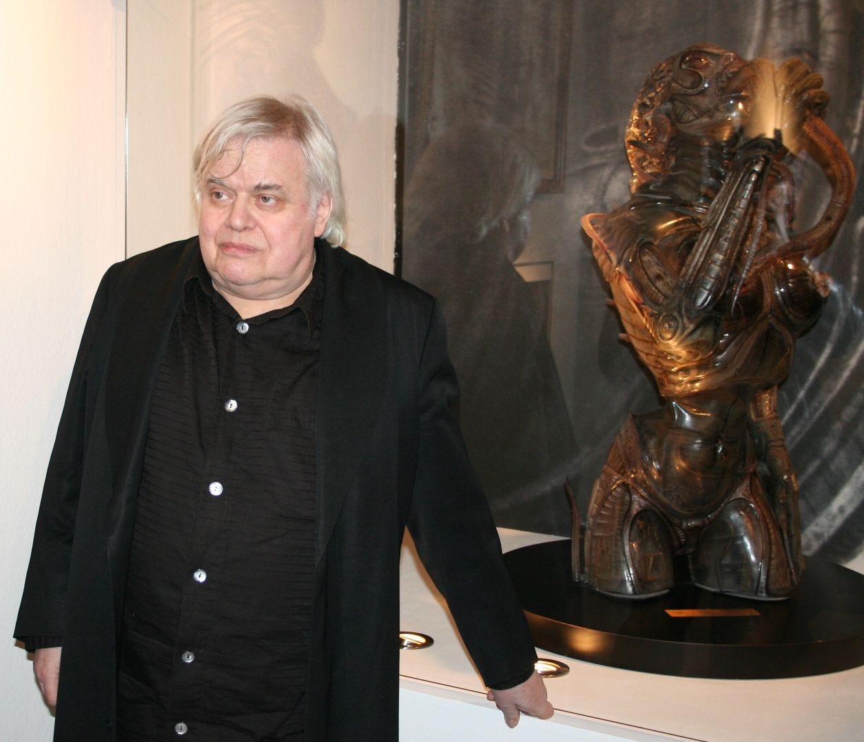 H. R. Giger photographed at the Deutsches Filmmuseum in Frankfurt, next to his Sil bust from the film Species H. R. Giger photographed at the Deutsches Filmmuseum in Frankfurt, next to his Sil bust from the film Species