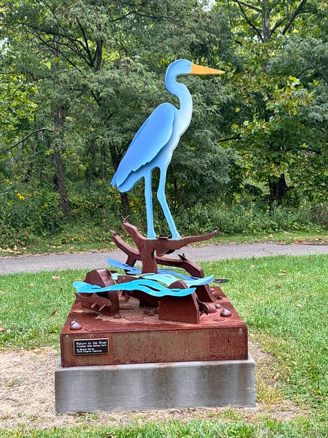 Blue heron statue, pumpkins on wagon, MD Garage at night, trail leading toward tunnel, mural in Canal Fulton, deck overlooking wetland