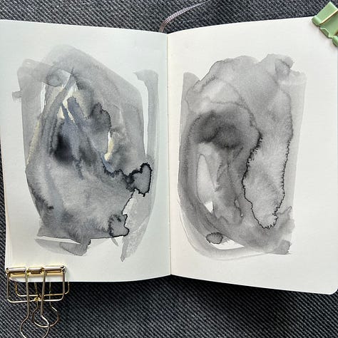 Different pages in a small sketchbook painted with light washes of watercolor in a variety colors