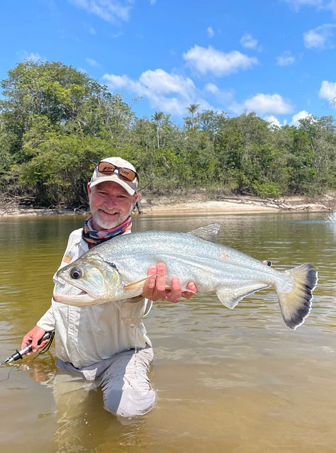 angler with large permit standing in the water