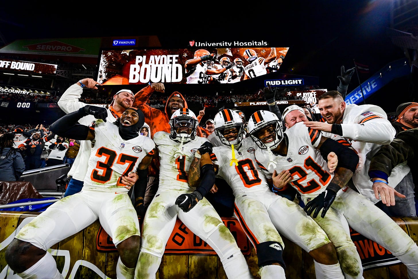 The Cleveland Browns defensive backs celebrate with their fans as they clinch a 2023 playoff birth.
