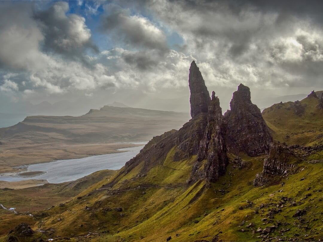Rocky pinnacles overlook a loch and islands beyond