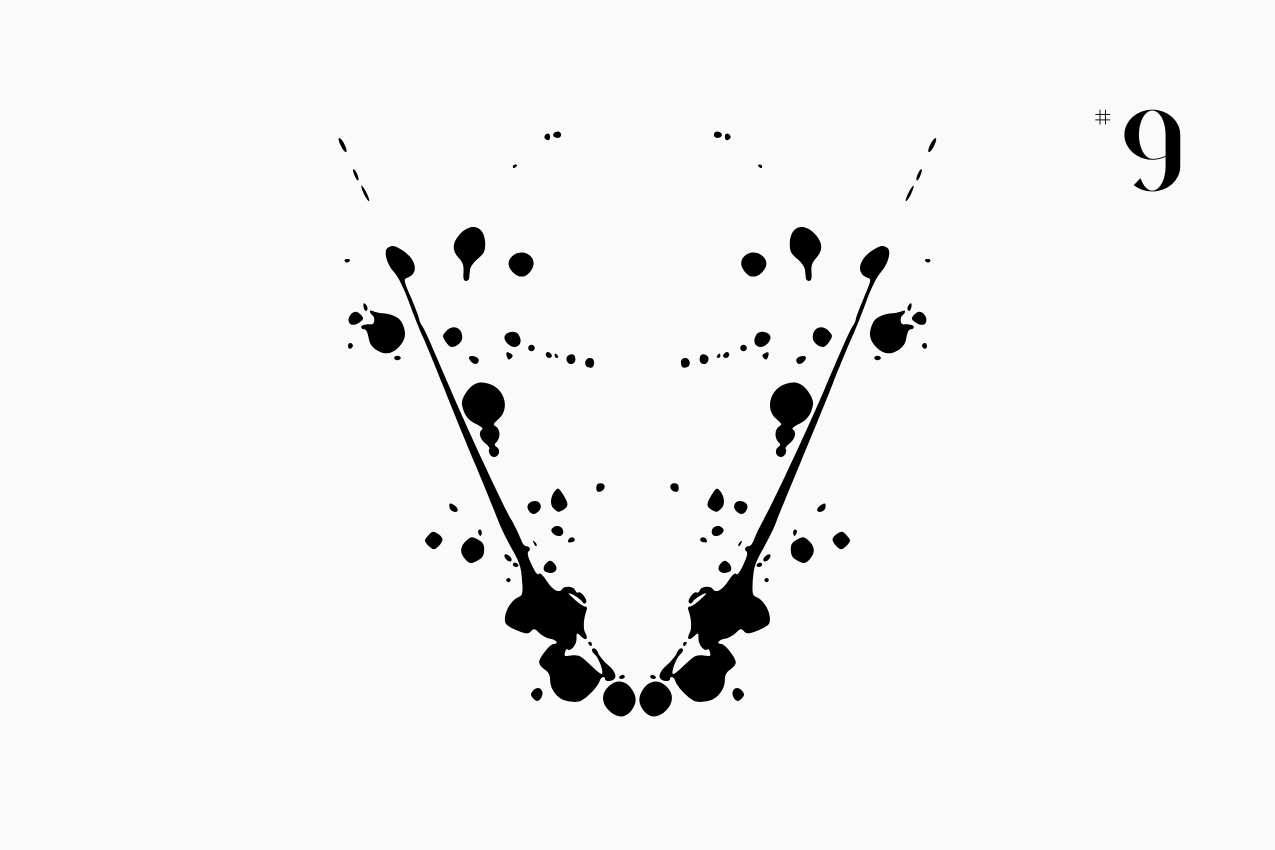 A bilateral, Rorschach-style inkblot specimen for the “In Other Words” series from The Subtext Review. The charcoal-black symmetrical splatter is centered on a cream paper background, labeled as Puzzle No. 9 in a classic serif typeface.