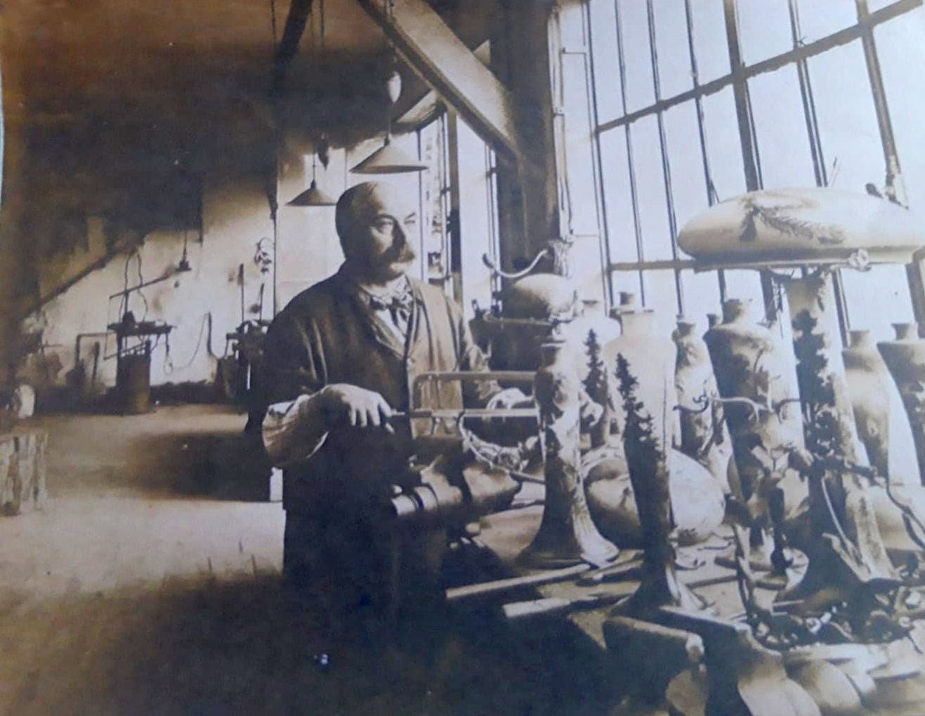 The lamp mounting workshop in the Gallé factory, anonymous undated picture (from the early 1920s?). The pictured worker could be Eugène Waechter (b. 1879), attested in 1911 and still active in 1931. The lamp mounting workshop in the Gallé factory, anonymous undated picture (from the early 1920s?). The pictured worker could be Eugène Waechter (b. 1879), attested in 1911 and still active in 1931.