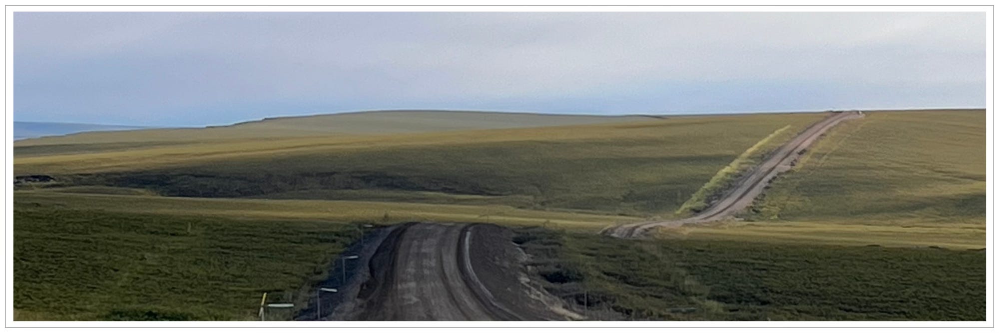 long road in silent landscape depicting pilgrimage