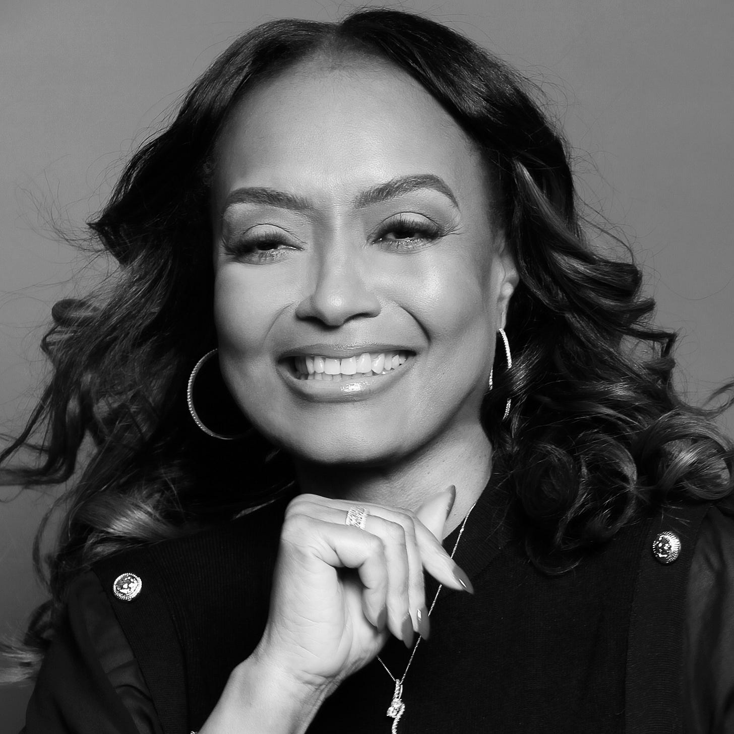 A woman smiles at the camera