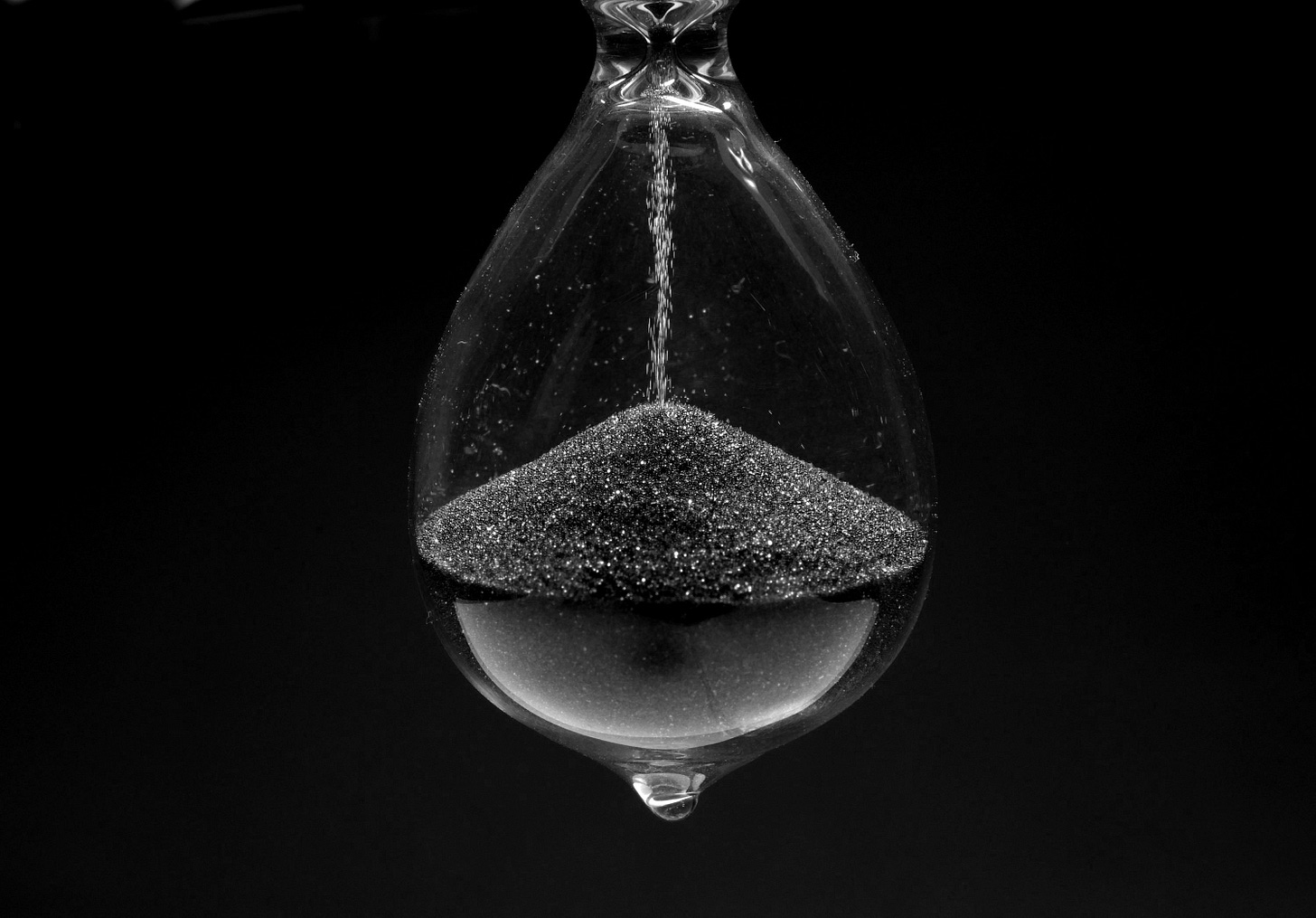 a blue substance in a glass hanging from a hook a blue substance in a glass hanging from a hook