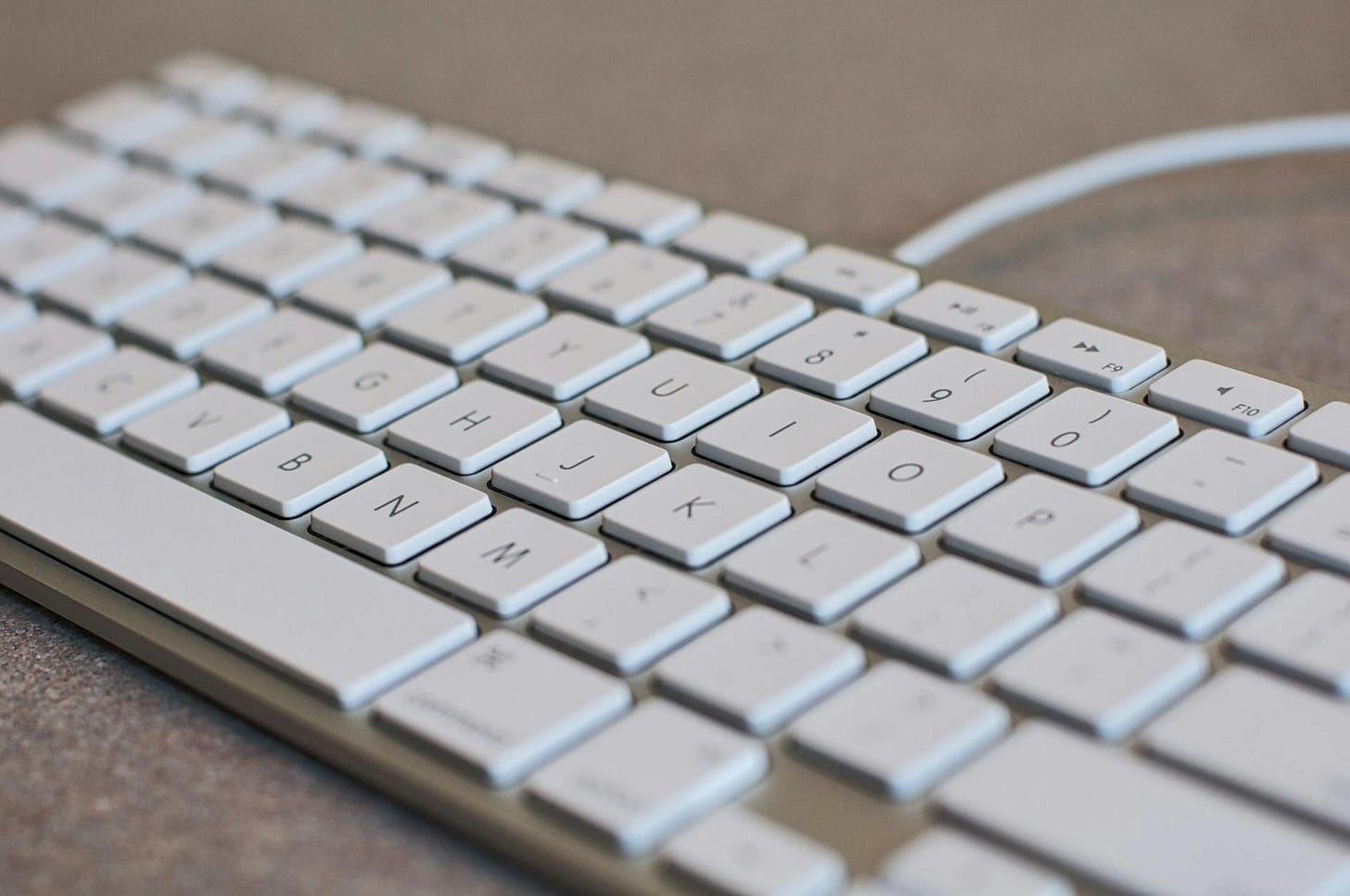 Photo of a plain old white computer keyboard Photo of a plain old white computer keyboard