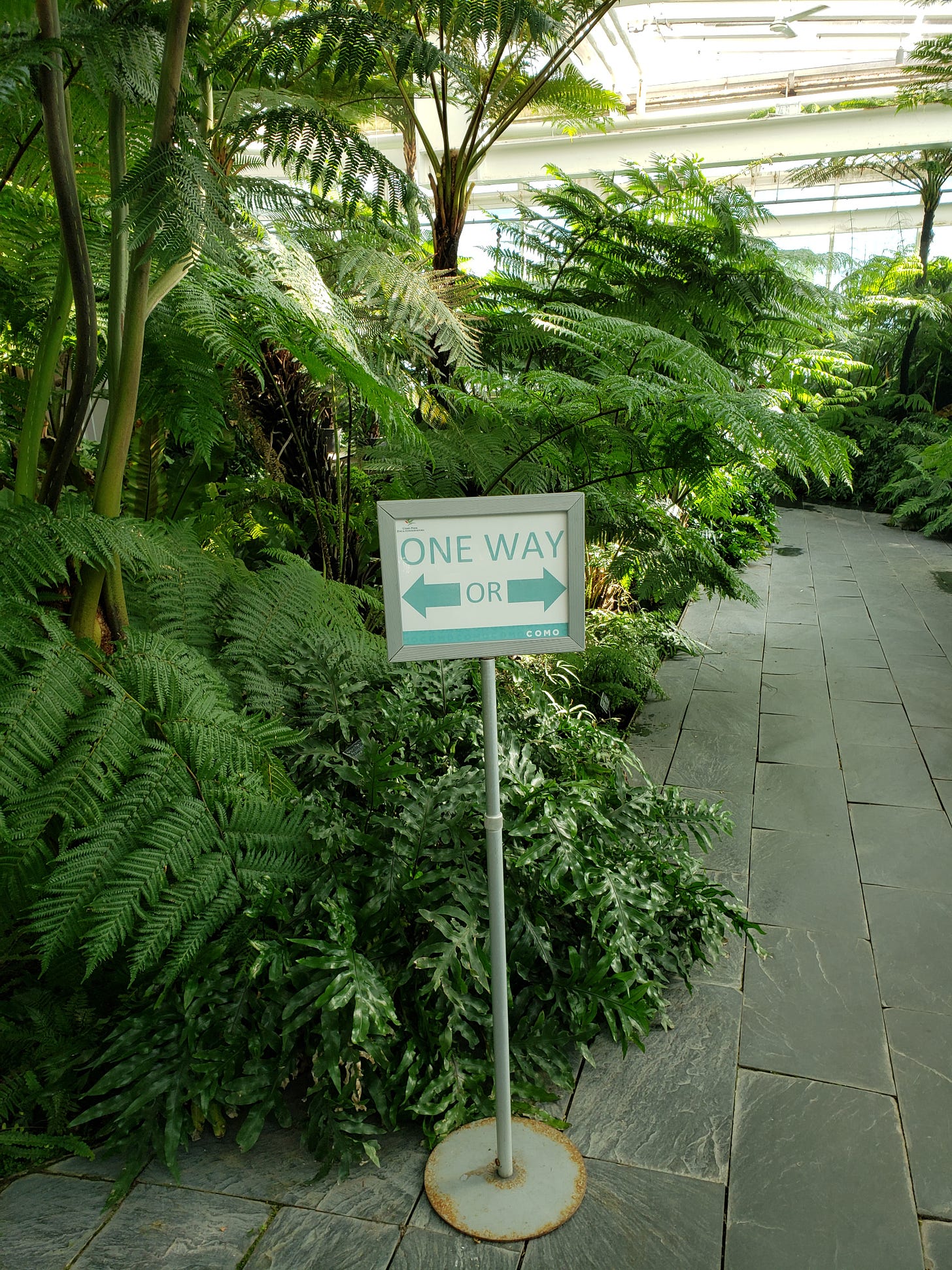 A sign that says ONE WAY with arrows pointing in both directions for the visitor to choose which direction to proceed.
