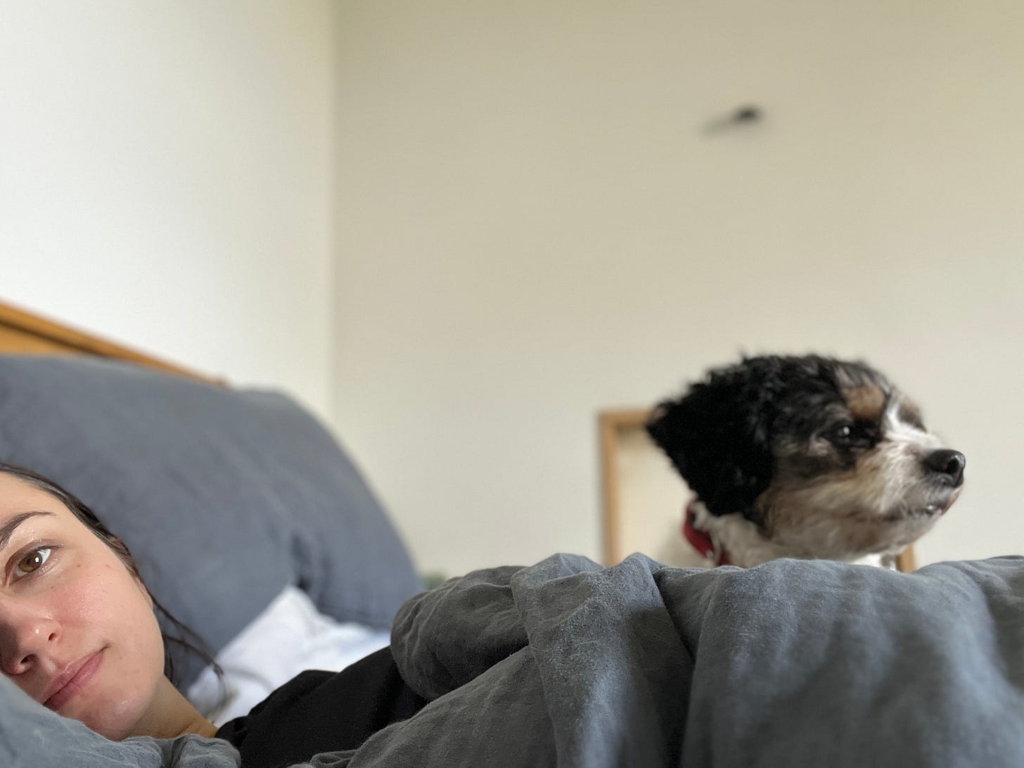 Charlie in bed with her dog Coco.